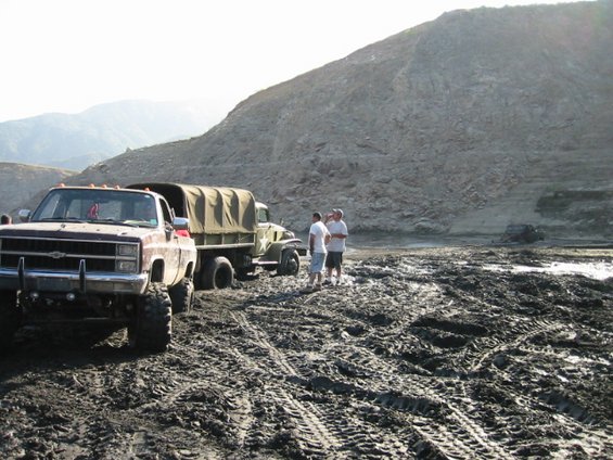 110-1037_img.jpg Military truck with 3 anchors behind him winching Carlos out