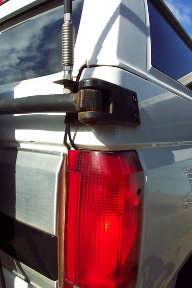 20070613---cb-antenna-mount-001.jpg CB Radio Antenna Mount 
Mounted to Tire Carrier Bracket 
(can't depend on the swing arm pin for good ground)
Swing arm in latched position.

Coax routed through tail light.  Used a round file to make a small little notch in top of tail light lens.