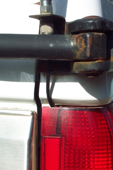 20070613---cb-antenna-mount-002.jpg CB Radio Antenna Mount 
Mounted to Tire Carrier Bracket 
(can't depend on the swing arm pin for good ground)
Swing arm in latched position.

Coax routed through tail light.  Used a round file to make a small little notch in top of tail light lens.
(Close-Up)