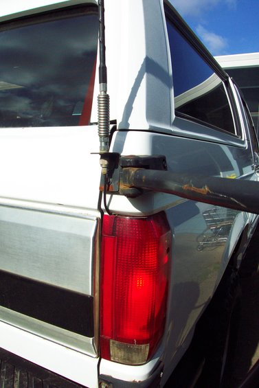 20070613---cb-antenna-mount-003.jpg CB Radio Antenna Mount 
Mounted to Tire Carrier Bracket 
(can't depend on the swing arm pin for good ground)
Swing arm in un-latched position.

Coax routed through tail light.  Used a round file to make a small little notch in top of tail light lens.