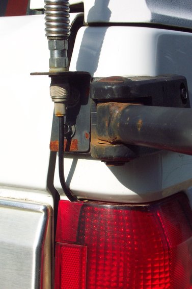 20070613---cb-antenna-mount-004.jpg CB Radio Antenna Mount 
Mounted to Tire Carrier Bracket 
(can't depend on the swing arm pin for good ground)
Swing arm in un-latched position.

Coax routed through tail light.  Used a round file to make a small little notch in top of tail light lens.
(Close-Up)