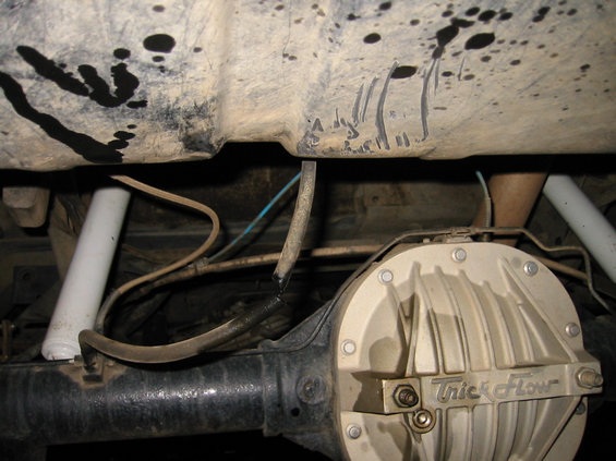 102-0298_img.jpg hard to tell, but there is a small dent in the gas tank and the vent line was cut by a rock