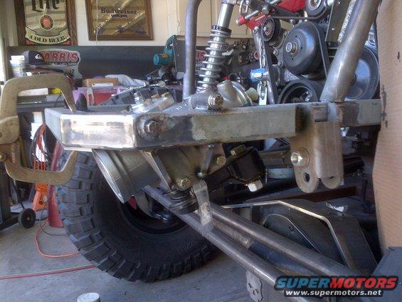 Custom front suspension and bumper with large tire visible