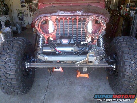 Red Jeep CJ-series front end with winch and large tires