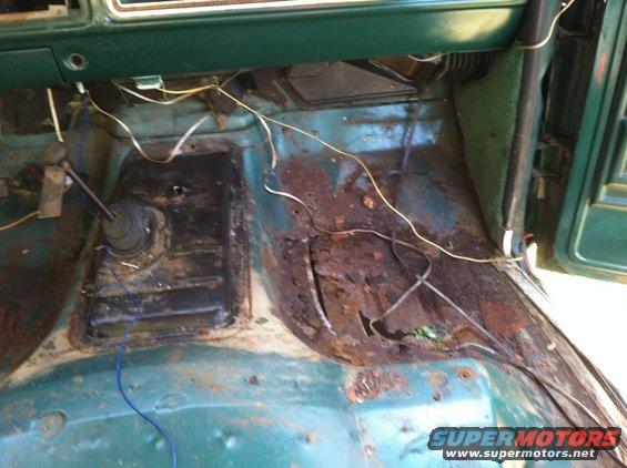 Rusted interior floor and transmission tunnel of a 1978 Ford Bronco
