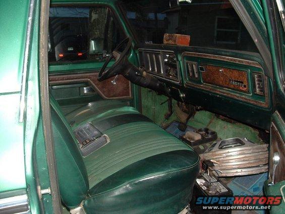Green interior of a 1978 Ford Bronco with woodgrain trim and two-tone seats
