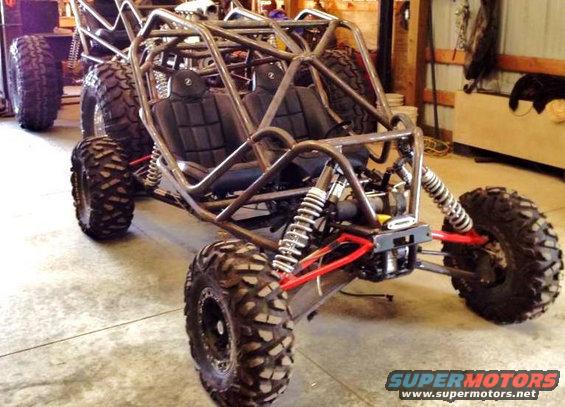 Custom dune buggy with roll cage and off-road tires, front 3/4 view