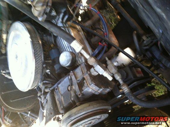 Engine bay with air filter and hoses visible
