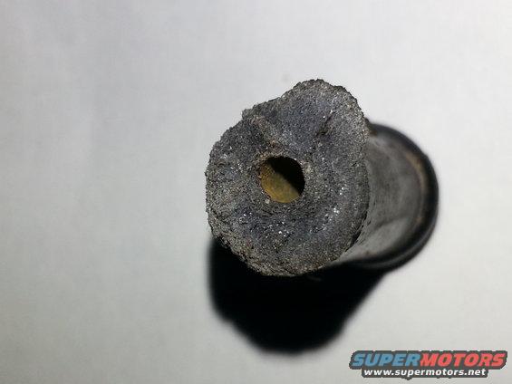 Worn rubber hose end with debris buildup