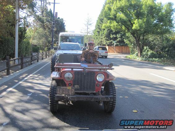 1946 Jeep CJ5 front view, red, with man driving