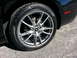 2013 Ford Mustang - A close-up view of the wheel and tire assembly on a black Ford Mustang, highlighting the vehicle's design details.