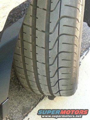 Close-up of a tire tread with Supermotors logo visible