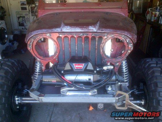 Red Jeep CJ front with Warn winch and large tires