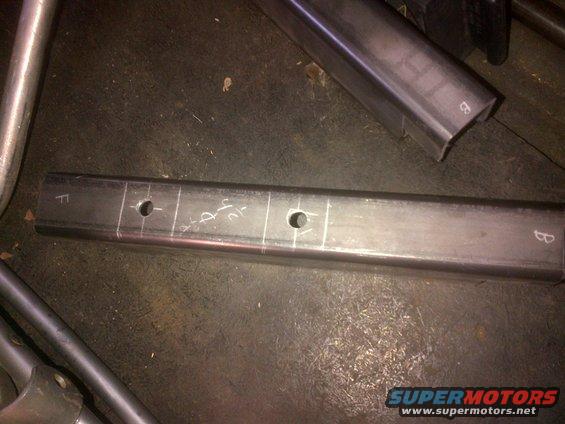metal tube with chalk marks and drilled holes