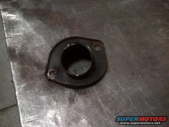 Exhaust flange with two bolt holes on a metal surface