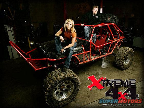 Red custom off-road buggy with two people, large tires