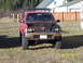 1991 Toyota Pickup/SR5 - Front view of a red 1991 Toyota Pickup/SR5 with its hood open, showing the engine bay.
