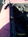 1991 Toyota Pickup/SR5 - Close-up of a black metal bracket on a red vehicle's fender, with engine bay details.