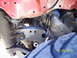 1991 Toyota Pickup/SR5 - Close-up view of the front suspension system of a vehicle, showing wear and tear.