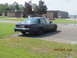 2003 Ford Crown Victoria - Black 2003 Ford Crown Victoria parked near a building with people in the background.