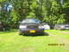 2003 Ford Crown Victoria - Front view of a 2003 Ford Crown Victoria, parked outdoors with other vehicles visible.