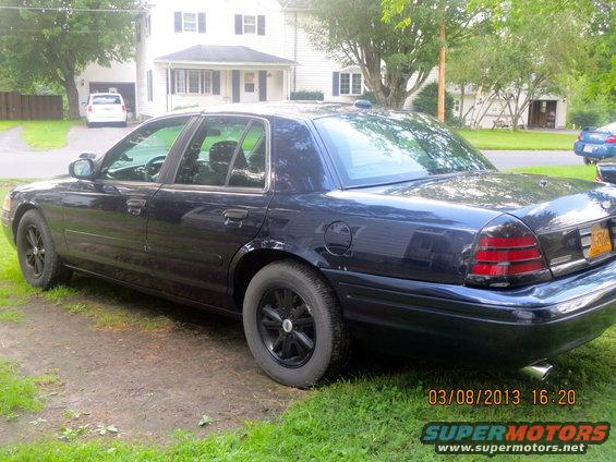 Dark blue 2003 Ford Crown Victoria, rear quarter view