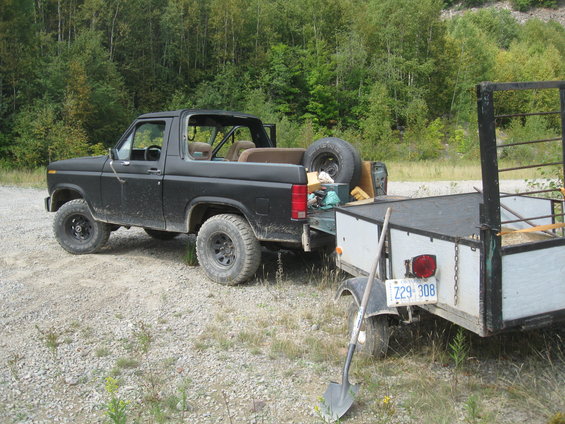 Black 1981 Ford Bronco with removable top, towing a trailer