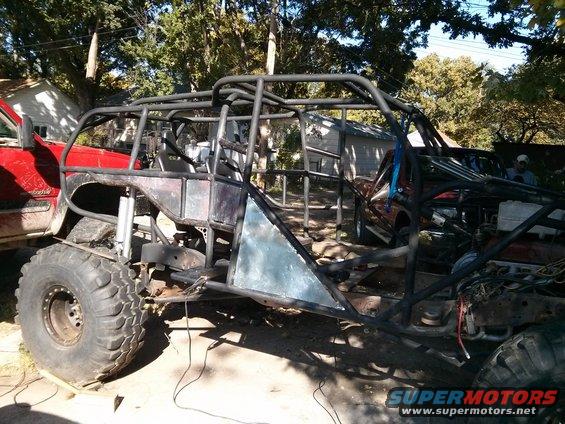 Custom off-road buggy side view with roll cage and large tires
