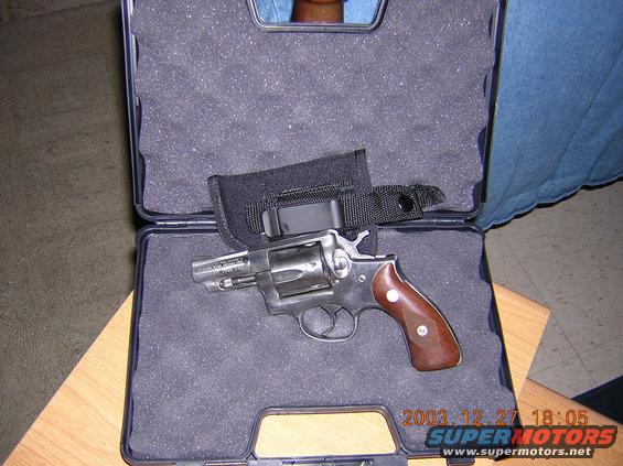 revolver with wood grips in a black case
