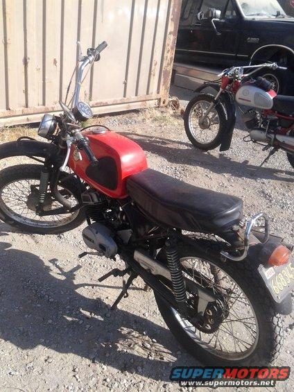 Red motorcycle side view, with another motorcycle behind it