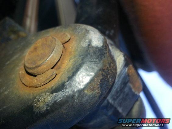 Close-up of rusted bolt and bracket assembly