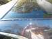 1998 Lincoln Mark VIII - The rear window seal of a dark-colored car is visible, with a reflection of the photographer and a date stamp.