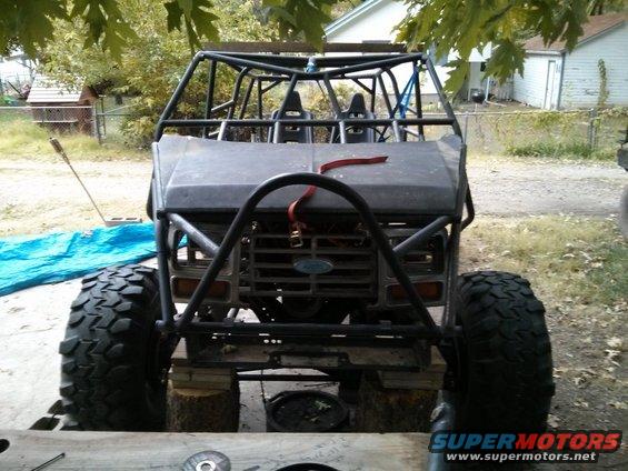Custom buggy built on a Ford truck chassis, front view. Roll cage covers the cabin and engine bay
