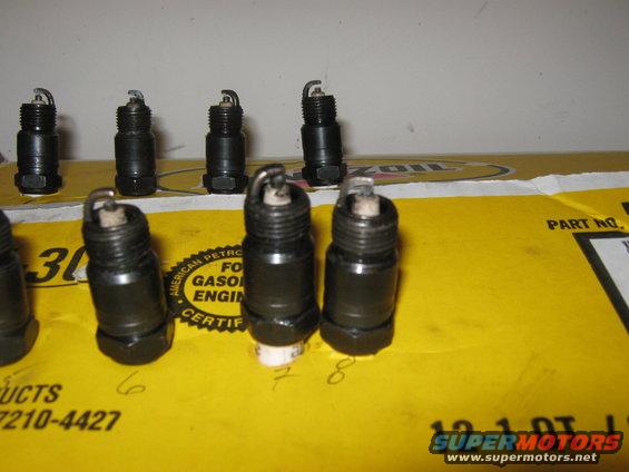 Spark plugs on yellow box with text