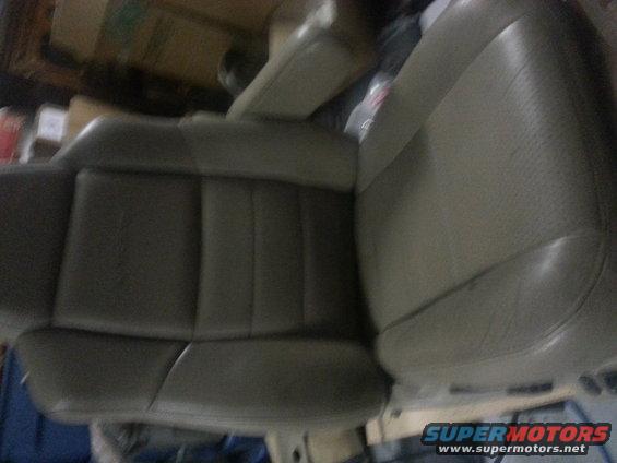 Tan leather car seat with visible stitching detail