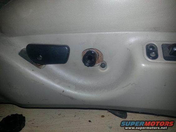 Car seat interior with black lever and exposed bolt