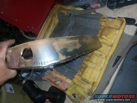 Rusty metal seat frame with yellow foam padding