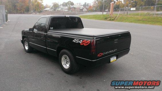 Black 1990 Chevrolet Silverado 1500 pickup truck with a tonneau cover and 454 SS badging