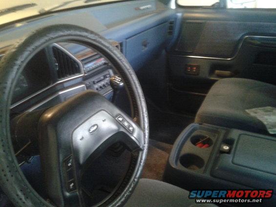 1988 Ford Bronco interior showing steering wheel, dashboard, and center console