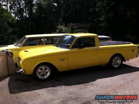 1963 Ford Ranchero pickup truck, yellow paint, aftermarket wheels, parked next to a yellow station wagon