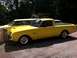 1963 Ford Ranchero - This yellow 1963 Ford Ranchero is parked next to another yellow vehicle.