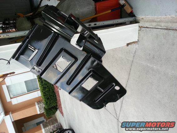 black metal undercarriage part with square cutouts