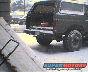 1980 Ford Bronco parked outside in the snow, rear view