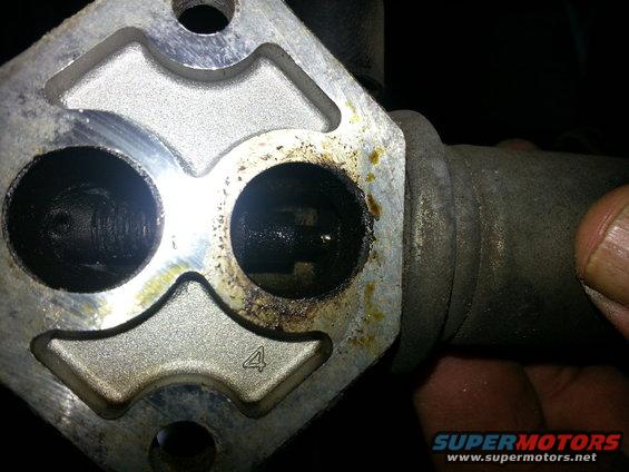 Throttle body with two circular openings, one marked with a '4'