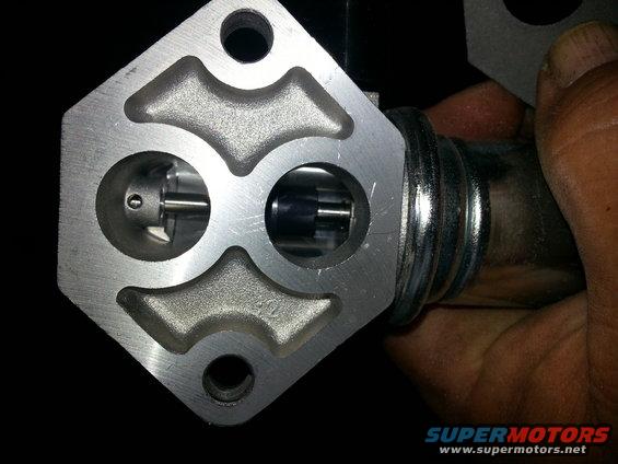 Close-up of a throttle body part with internal mechanisms visible