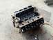 1978 Ford Bronco - Engine block with internal components exposed, sitting on a rough ground surface.
