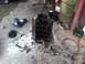 1978 Ford Bronco - Disassembled engine block and associated parts scattered on a workshop floor.