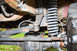 1989 Ford Bronco - Undercarriage view of a vehicle's suspension system with visible rust and wear.