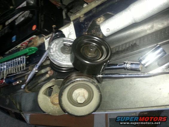 Alternator pulley and tensioner assembly with socket wrench and other tools