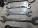 2004 Aston Martin Virage - A collection of various metal wrenches, some showing brand names and sizes.